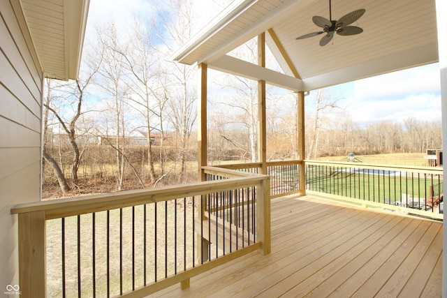 deck featuring ceiling fan and a yard