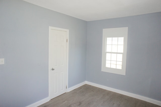 empty room with dark wood-type flooring