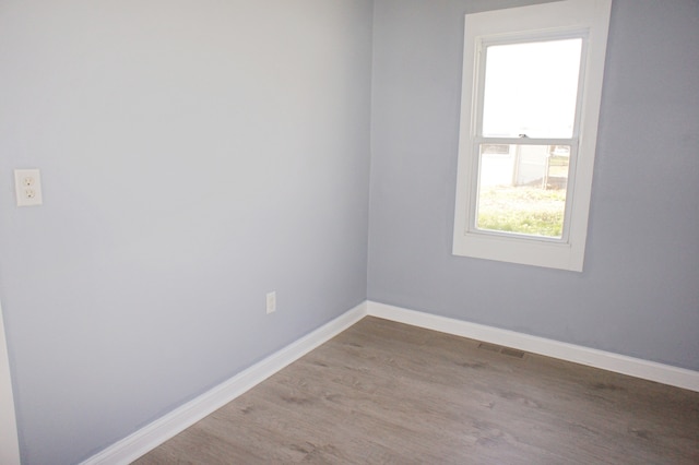 empty room featuring dark hardwood / wood-style flooring