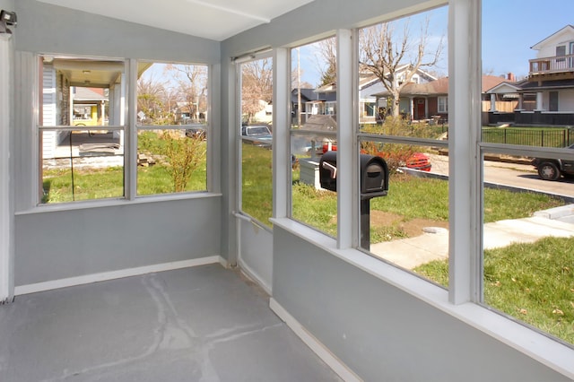 unfurnished sunroom with lofted ceiling and a healthy amount of sunlight