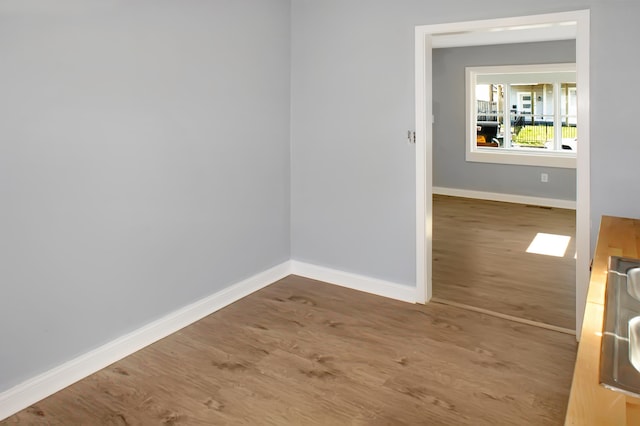 empty room with dark hardwood / wood-style flooring