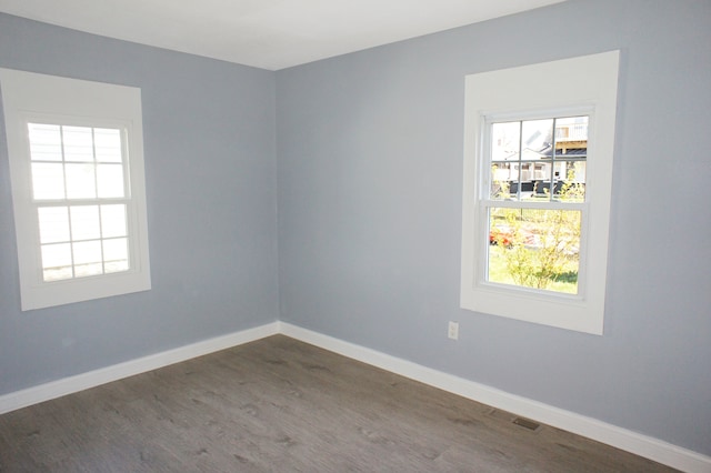 spare room featuring dark wood-type flooring