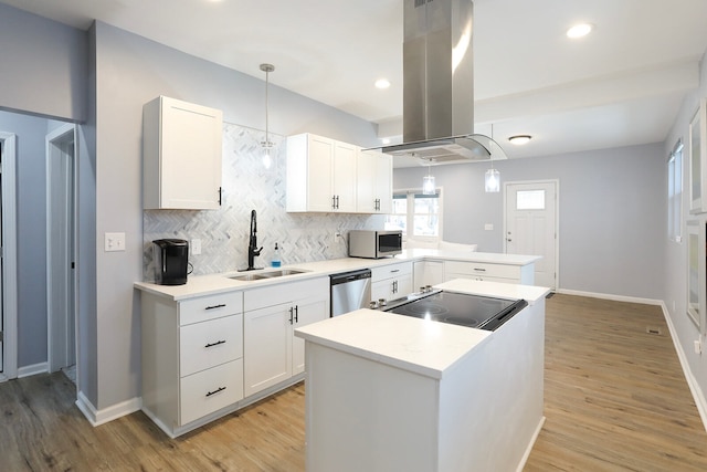 kitchen featuring light hardwood / wood-style floors, white cabinetry, stainless steel appliances, and island range hood