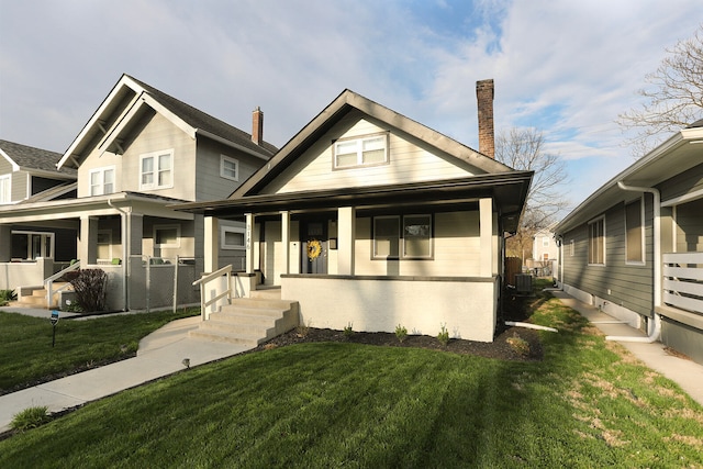 view of front of house with covered porch, central air condition unit, and a front lawn