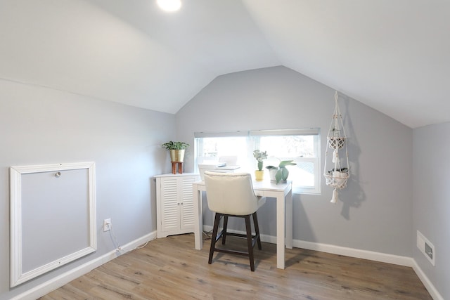 office space with light hardwood / wood-style flooring and vaulted ceiling