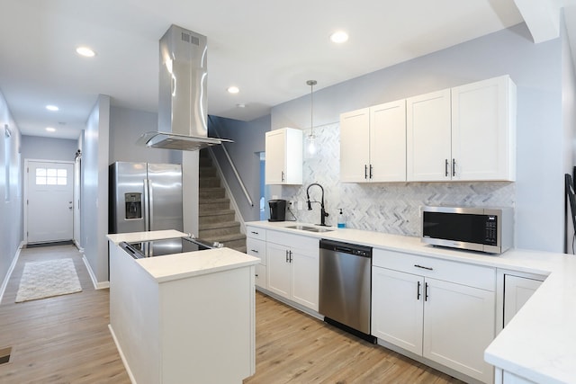 kitchen featuring light hardwood / wood-style flooring, sink, stainless steel appliances, and pendant lighting