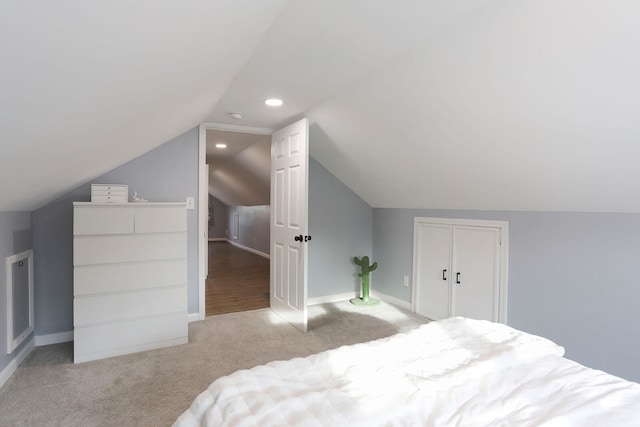 bedroom with lofted ceiling and light carpet