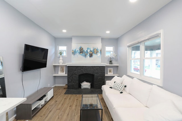 living room featuring light hardwood / wood-style floors and a fireplace