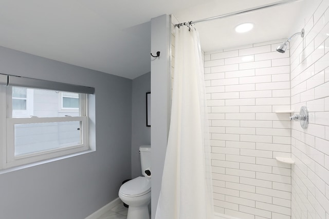 bathroom with tile floors, toilet, and a shower with shower curtain