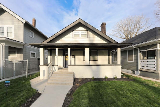 view of front of home with a porch and a front yard