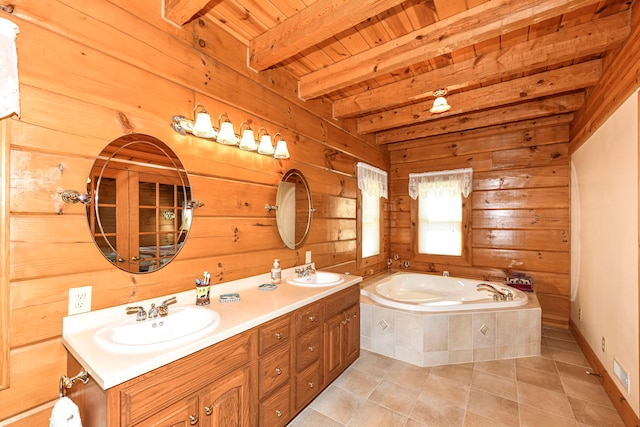 bathroom featuring beam ceiling, wooden ceiling, vanity with extensive cabinet space, a relaxing tiled bath, and dual sinks