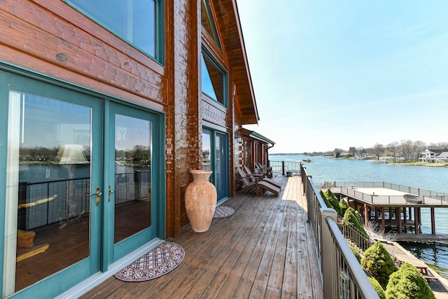 deck featuring a water view, a boat dock, and french doors