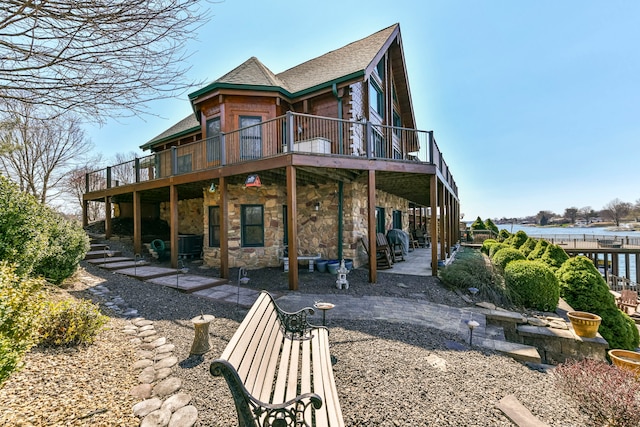 rear view of property with a patio and a wooden deck