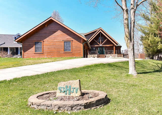 log cabin featuring a front lawn