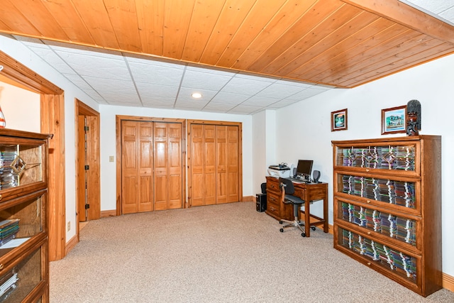 home office with a drop ceiling and light colored carpet