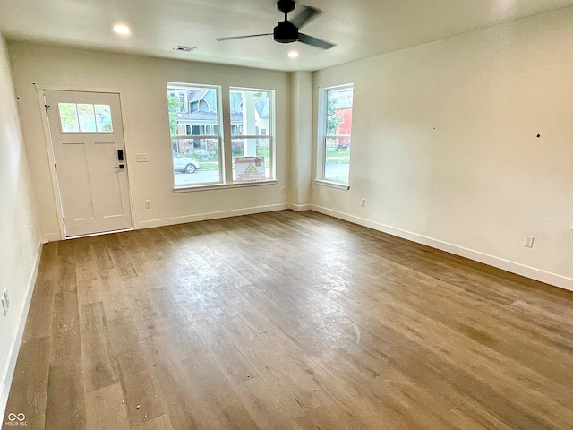 interior space with ceiling fan and wood-type flooring