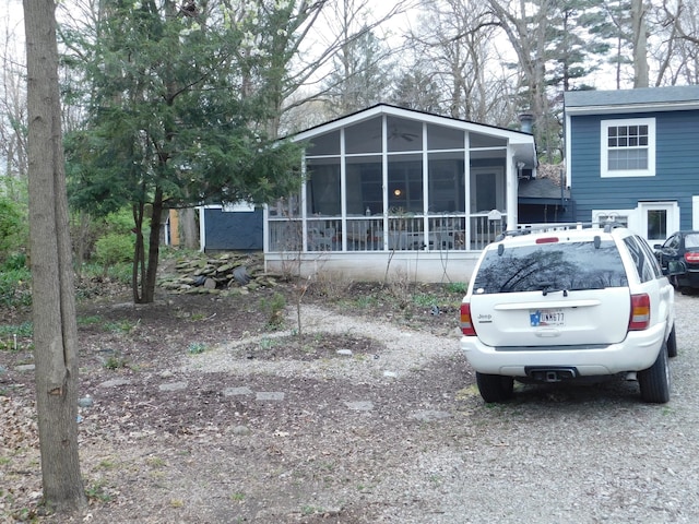 rear view of house featuring a sunroom