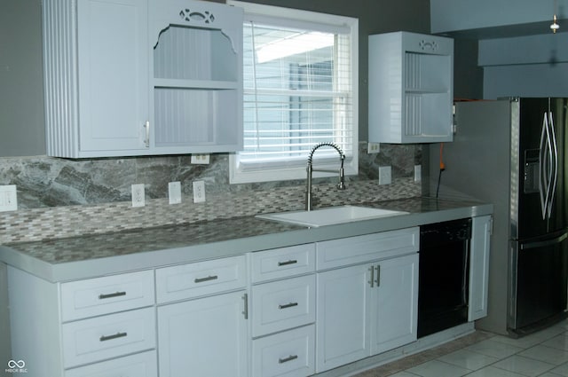 kitchen with white cabinets, backsplash, light tile patterned floors, and sink