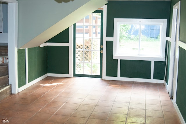 bonus room featuring a healthy amount of sunlight and tile patterned floors