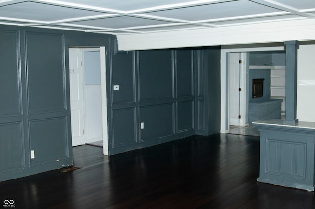 unfurnished room with dark hardwood / wood-style flooring