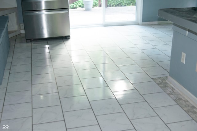 interior space featuring stainless steel refrigerator and tile patterned floors