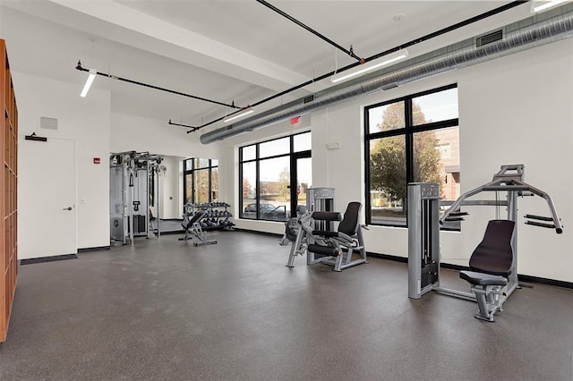 exercise room featuring a high ceiling