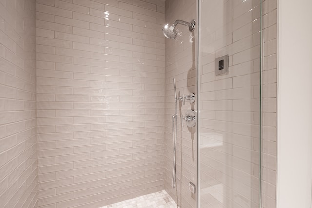 bathroom with a shower with shower door