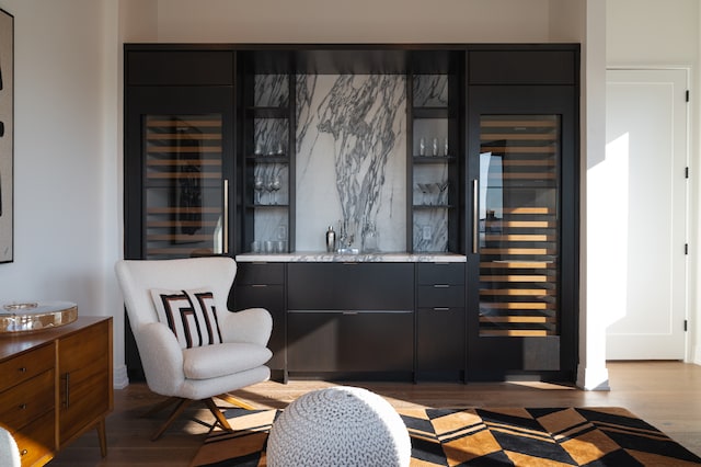 bar with wine cooler and light hardwood / wood-style flooring