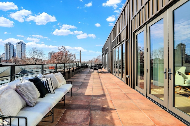 balcony with an outdoor living space and french doors