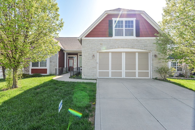 craftsman house with a garage and a front lawn