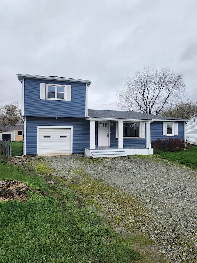 view of front of property featuring a front yard and a garage