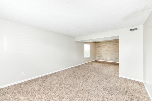 spare room featuring light colored carpet