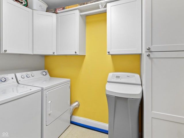 laundry room with cabinets and washing machine and clothes dryer