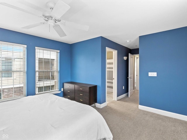 bedroom with ceiling fan and light carpet