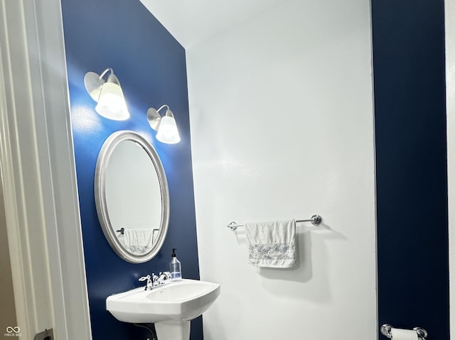 bathroom with lofted ceiling and sink