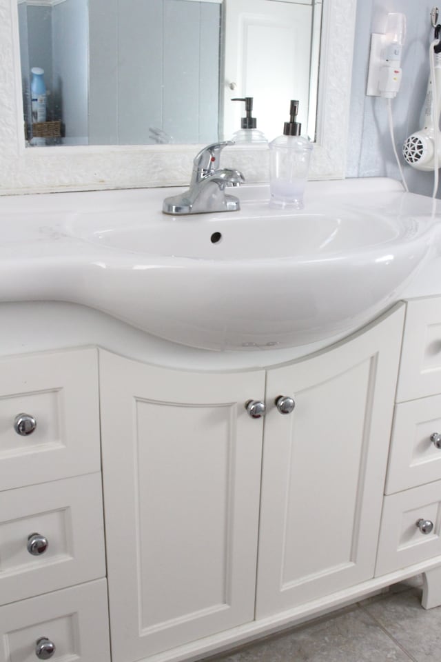 bathroom with tile patterned floors and vanity