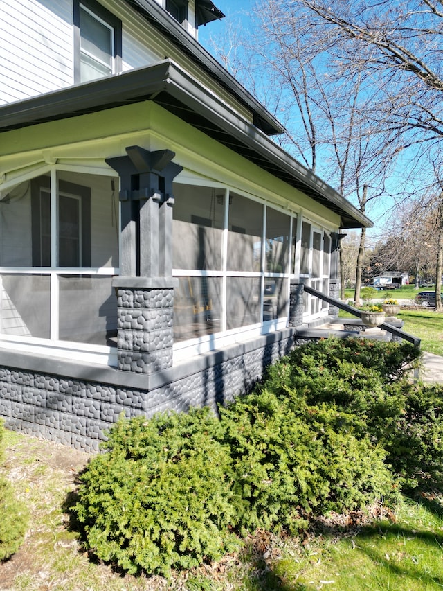 view of side of property with a sunroom