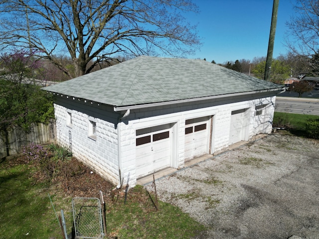 detached garage with fence and a gate