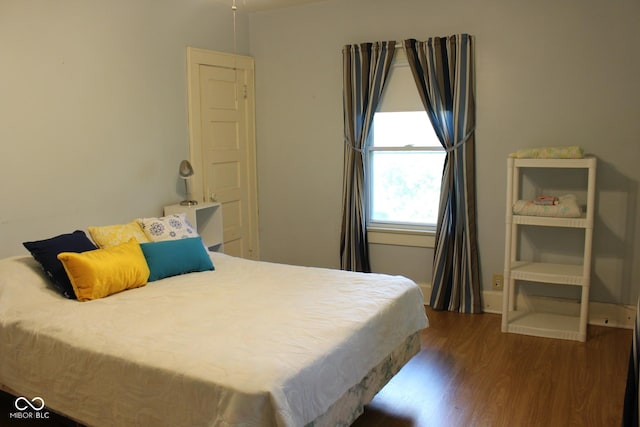 bedroom with wood finished floors