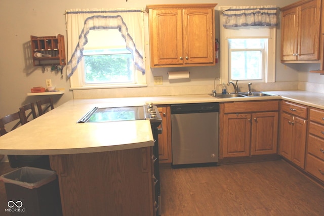 kitchen featuring a sink, dark wood finished floors, a peninsula, light countertops, and dishwasher