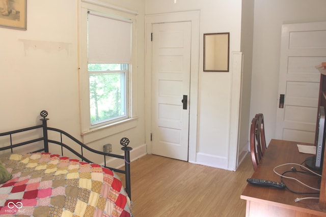 bedroom featuring baseboards and light wood-type flooring