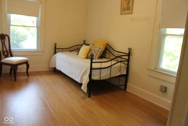 bedroom with baseboards and wood finished floors