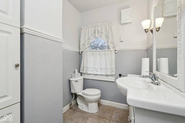 bathroom with vanity, tile patterned floors, toilet, and baseboards