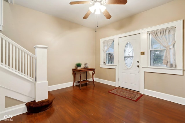 entryway with ceiling fan, stairway, baseboards, and wood finished floors