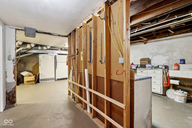 basement featuring white fridge