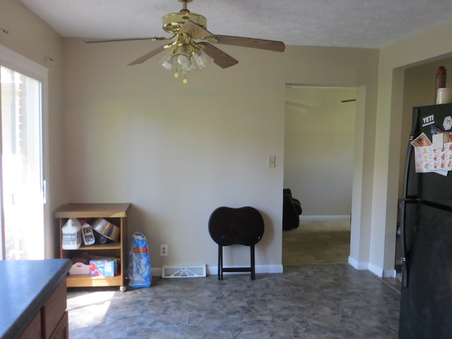 interior space with tile flooring and ceiling fan