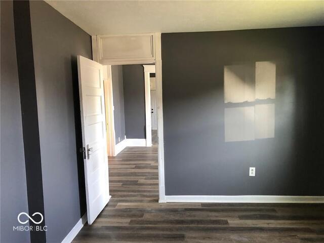 spare room featuring dark hardwood / wood-style flooring