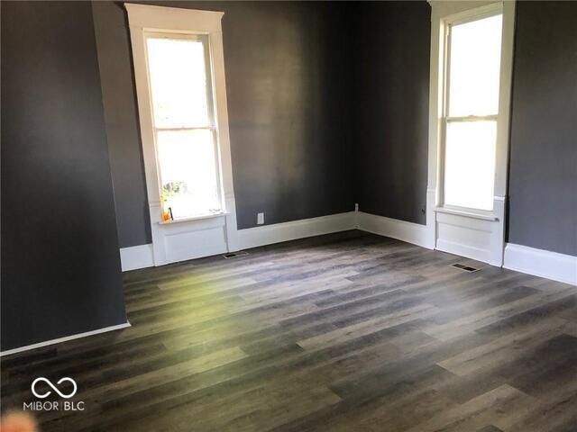 empty room with dark wood-type flooring