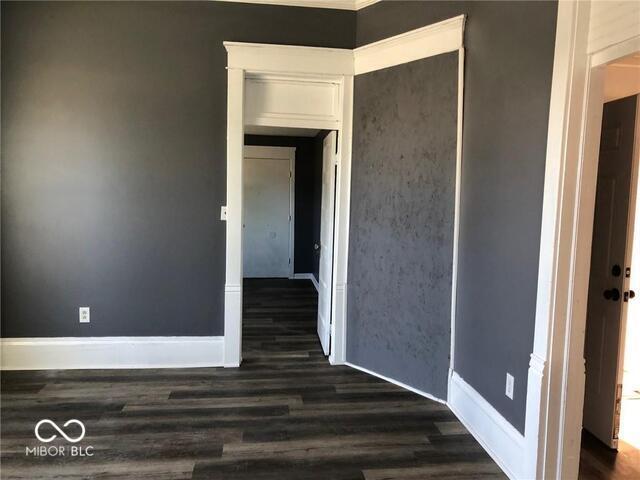 unfurnished room with dark hardwood / wood-style floors