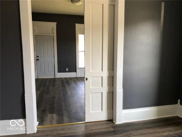 hall with dark hardwood / wood-style flooring